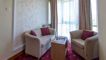 Deluxe Suite, Garden View | Living area | TV, stereo