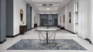 A spacious hotel lobby with a central round table, a patterned rug, and modern decor. - Embassy Suites by Hilton Birmingham Hoover (Birmingham)