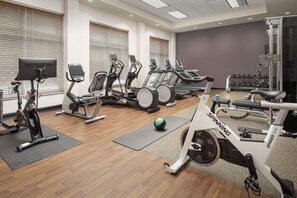A gym with various exercise equipment, including treadmills, ellipticals, and a spinning bike. - Embassy Suites by Hilton Birmingham Hoover (Birmingham)