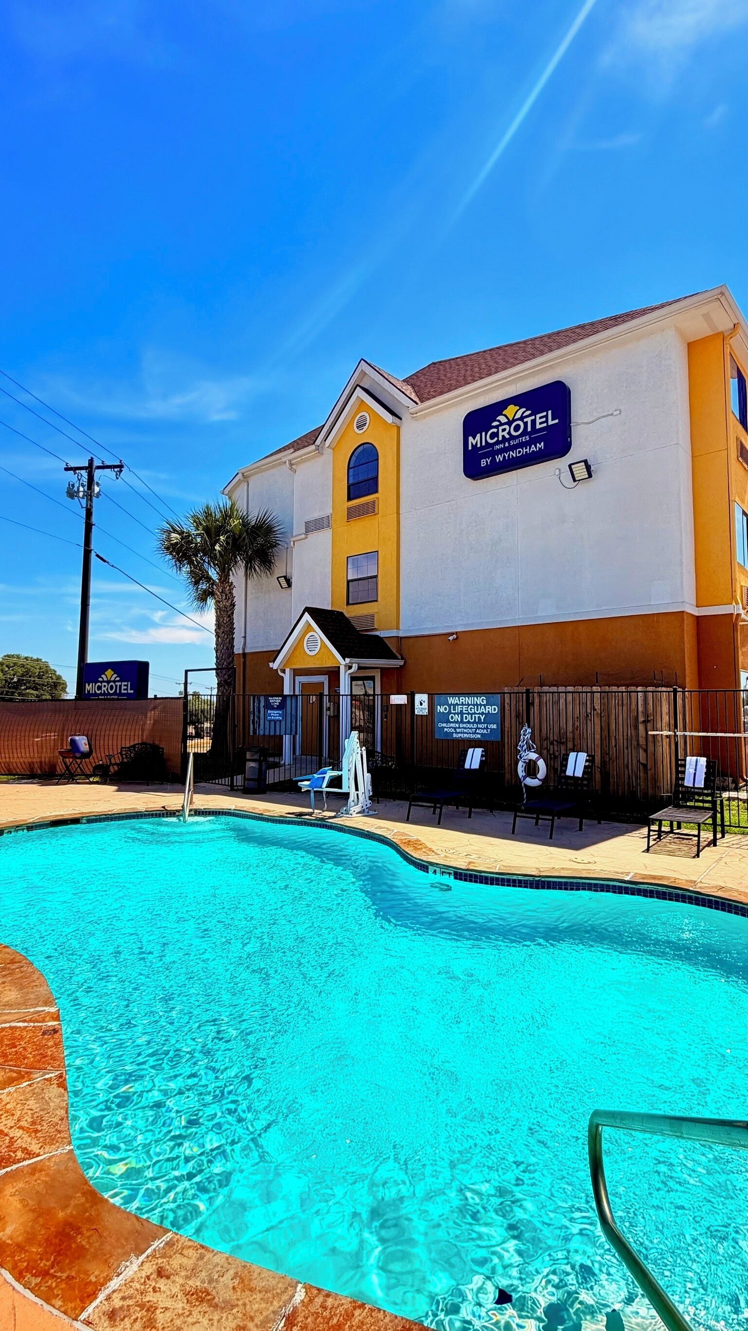 A Microtel Inn & Suites building with a swimming pool.