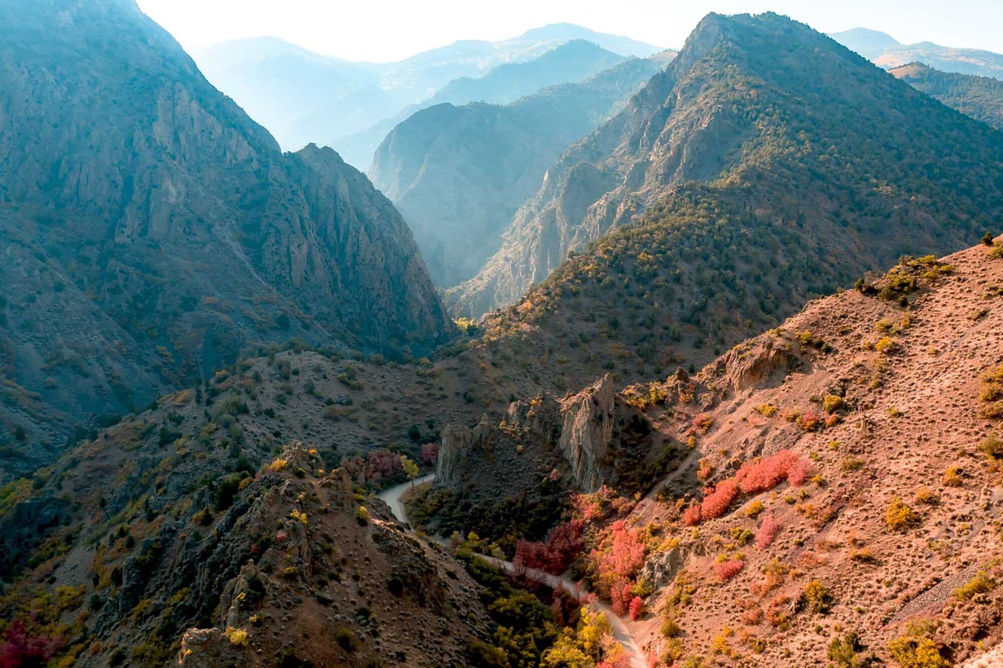 A mountainous landscape with a winding road.