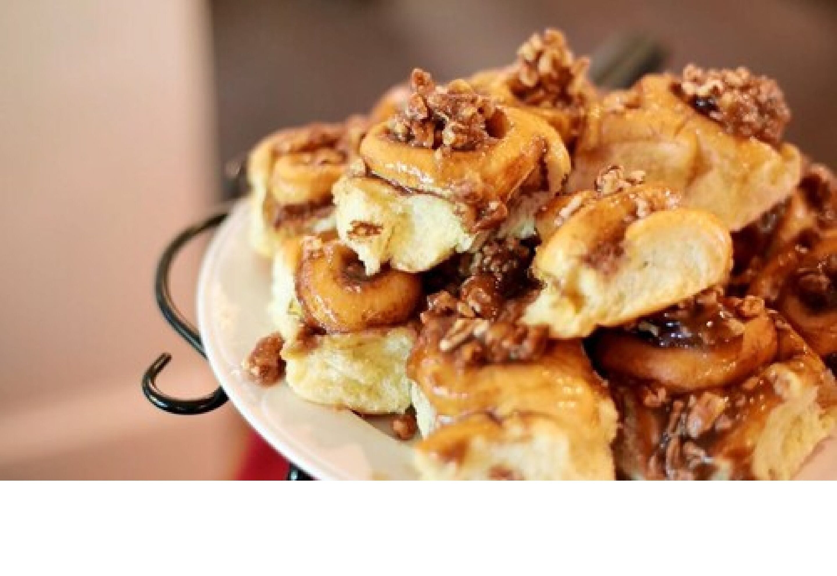 A plate of pancakes topped with syrup and nuts.