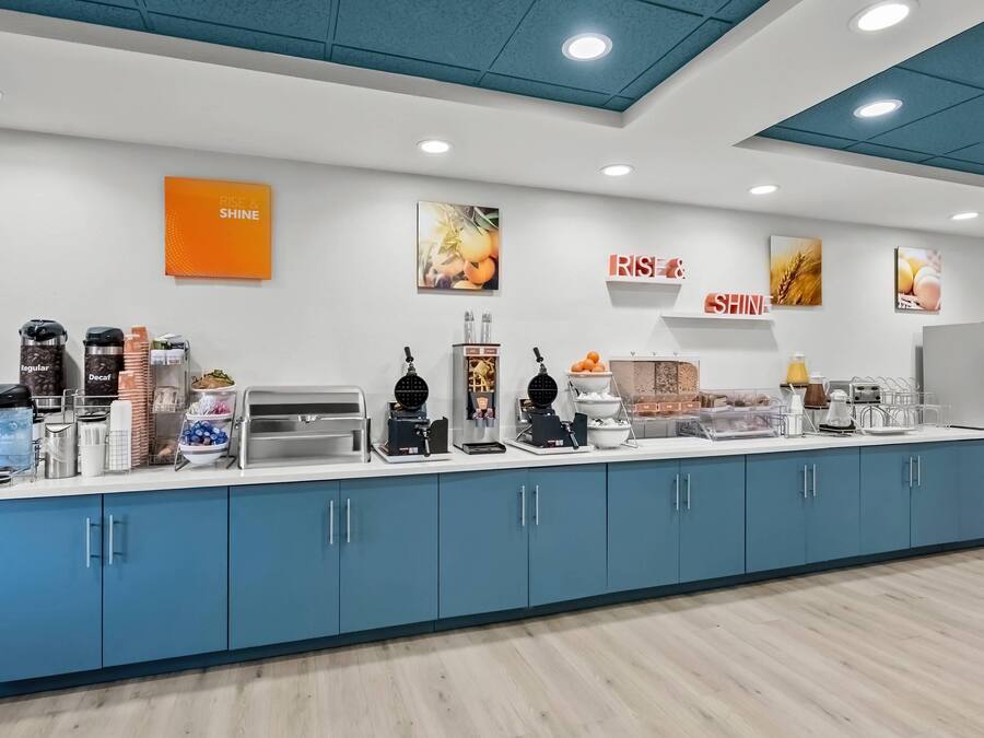 A breakfast bar with coffee machines, decaf, and a water cooler.