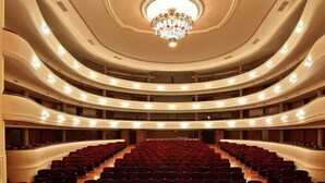 A multi-tiered auditorium with tiered seating and a central chandelier. - Crillon Mendoza (Mendoza)