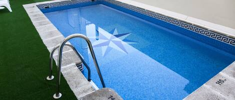Seasonal outdoor pool, pool loungers