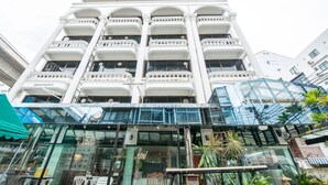 A multi-story hotel with a modern facade, large windows, and balconies.