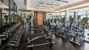 A gym with treadmills, weight machines, and dumbbells. - SC Park Hotel (Bangkok)