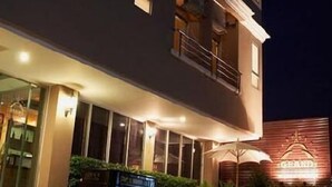 A multi-story hotel with a well-lit entrance and a visible restaurant area. - Grand Pinnacle (Bangkok)