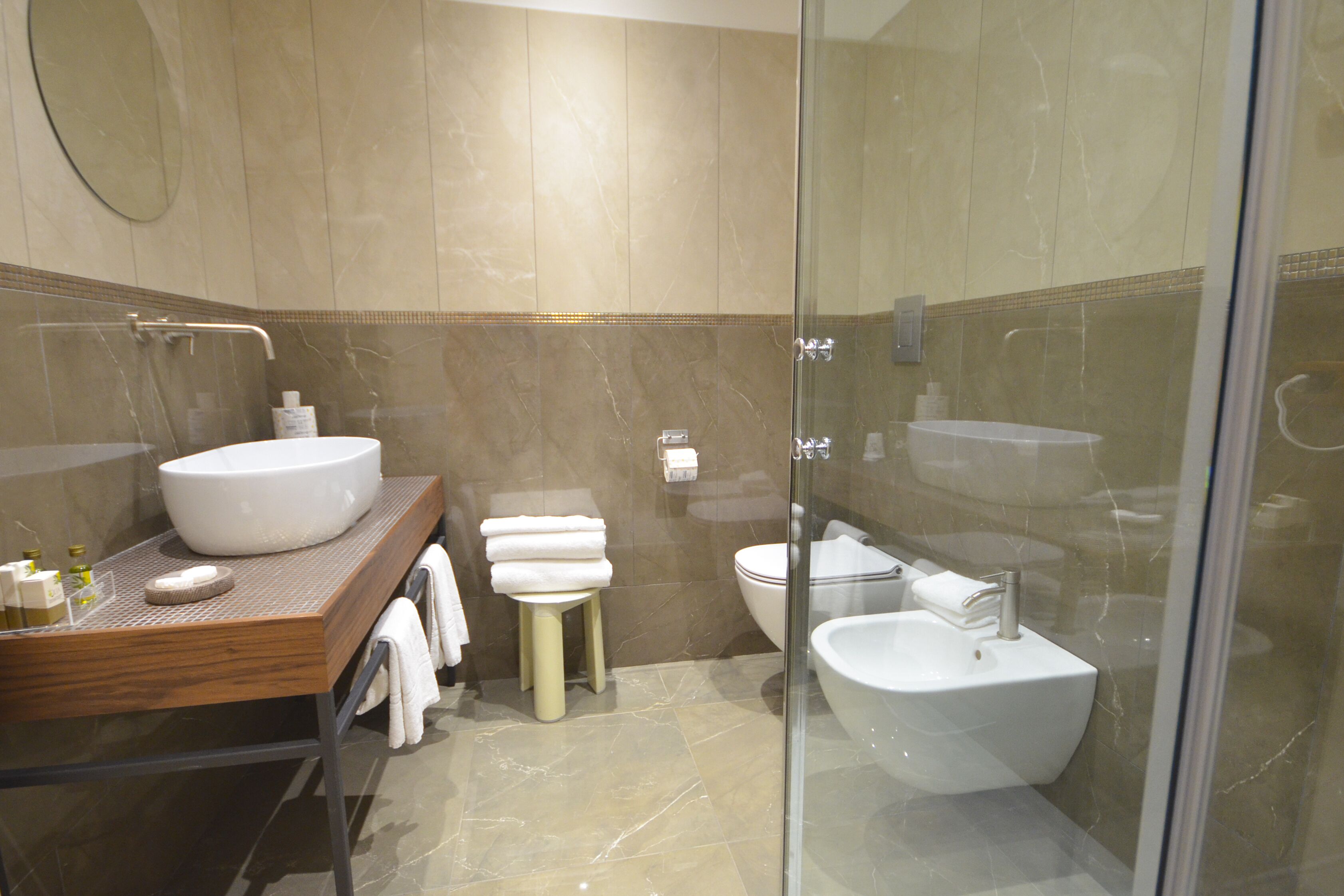 A modern bathroom with a large sink, toilet, and bidet.