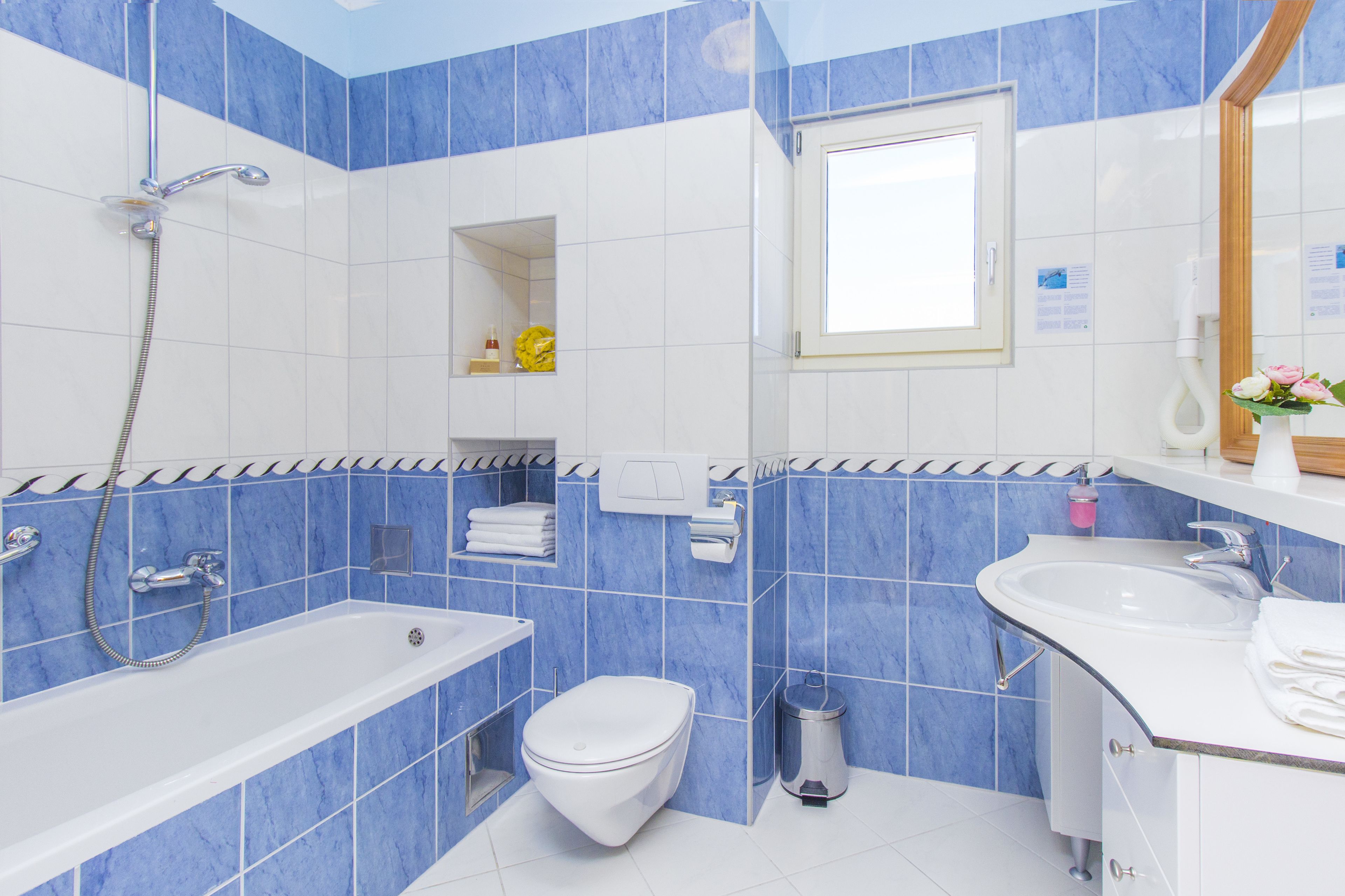 A modern bathroom with a bathtub, toilet, and sink.