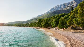 On the beach, beach cabanas, sun loungers, beach umbrellas