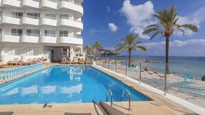 A pool area with lounge chairs and a view of the ocean. - Hotel Ibiza Playa (Ibiza Town)