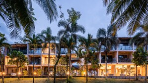 A multi-story hotel with a modern design, featuring balconies and large windows. - Kokotel Khao Lak Lighthouse (Takua Pa)