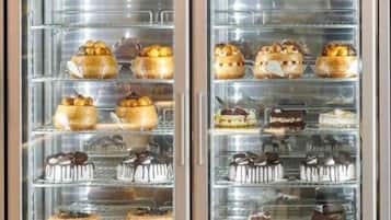A display case with various pastries and cakes.