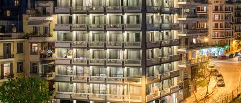 A multi-story hotel with a prominent sign reading "Park Hotel Park Hotel." The building features balconies with glass railings and multiple windows.