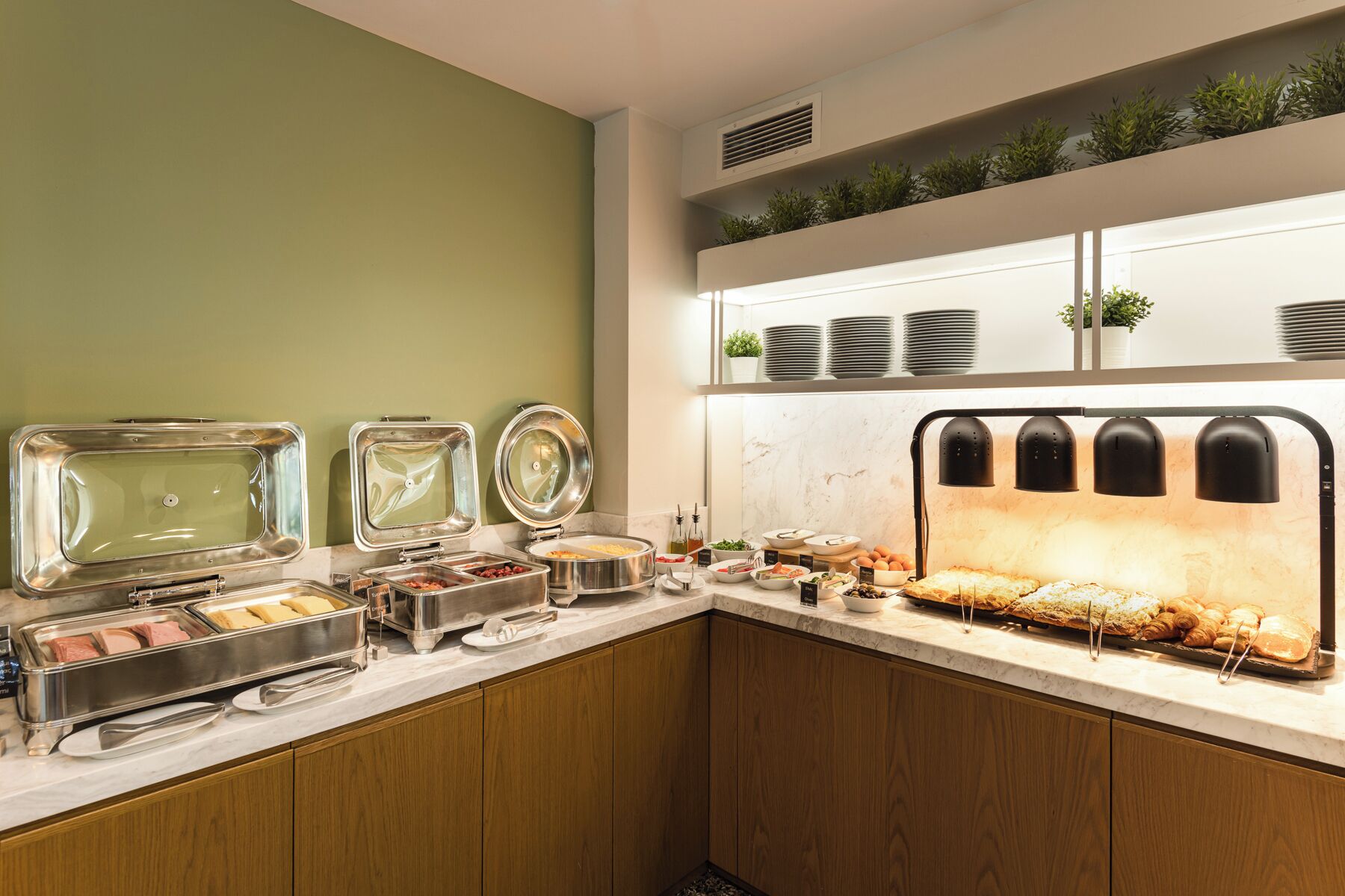 A buffet setup with various food items and containers.