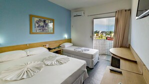 A hotel room with two beds, a small table, a chair, a window with a view of buildings, and an air conditioning unit. - Happy Ponta Negra Express (Natal)