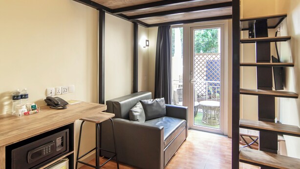 A compact room with a bunk bed, a kitchenette, a sofa, and a dining area. - Fragrance Hotel - Balestier (Singapore)