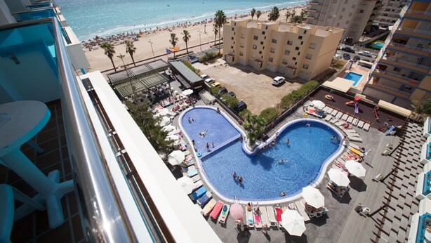 A hotel with a pool shaped like a heart, overlooking a beach. - Hotel Acuazul (Peniscola)
