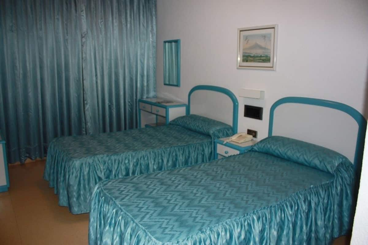 In-room safe, blackout drapes, WiFi (surcharge), bed sheets