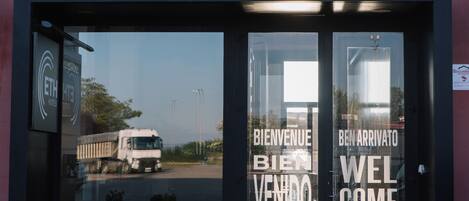 The entrance to Hotel ETH Rioja with a clear view of the reception area and a truck outside.