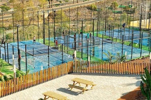 Enjoy a game of tennis on our outdoor court, surrounded by trees and a scenic view.