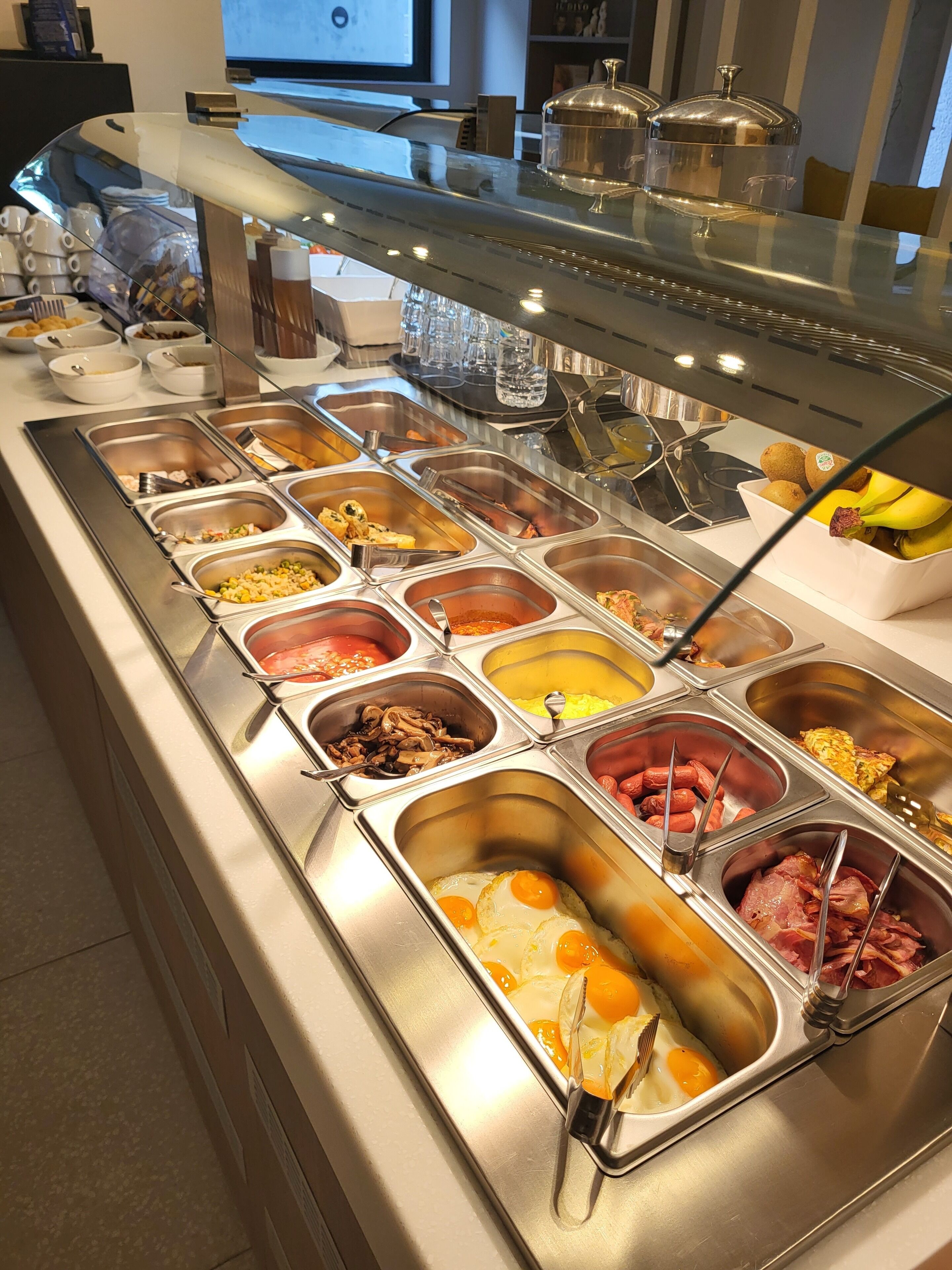 Ein reichhaltiges Buffet mit verschiedenen Speisen, darunter Eier, Fleisch und Obst.