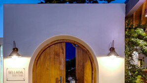 A wooden double door with a sign reading "SELADA beach hotel" above it.