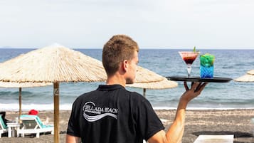 Enjoy a refreshing drink on the beach with a stunning ocean view.