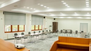 A conference room with a long table, chairs, and a projector. - Hotel Parc Sibiu (Sibiu)
