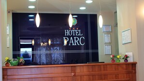 A reception desk with a sign reading "HOTEL PARC" and three framed certificates on the wall. - Hotel Parc Sibiu (Sibiu)