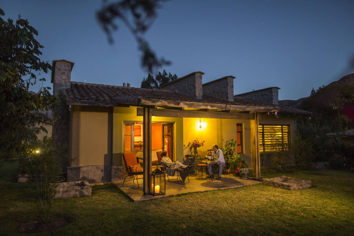 A house with a patio, a dining area, and a person sitting at a table.