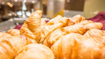 A close-up of golden-brown pastries, likely croissants, arranged on a tray.