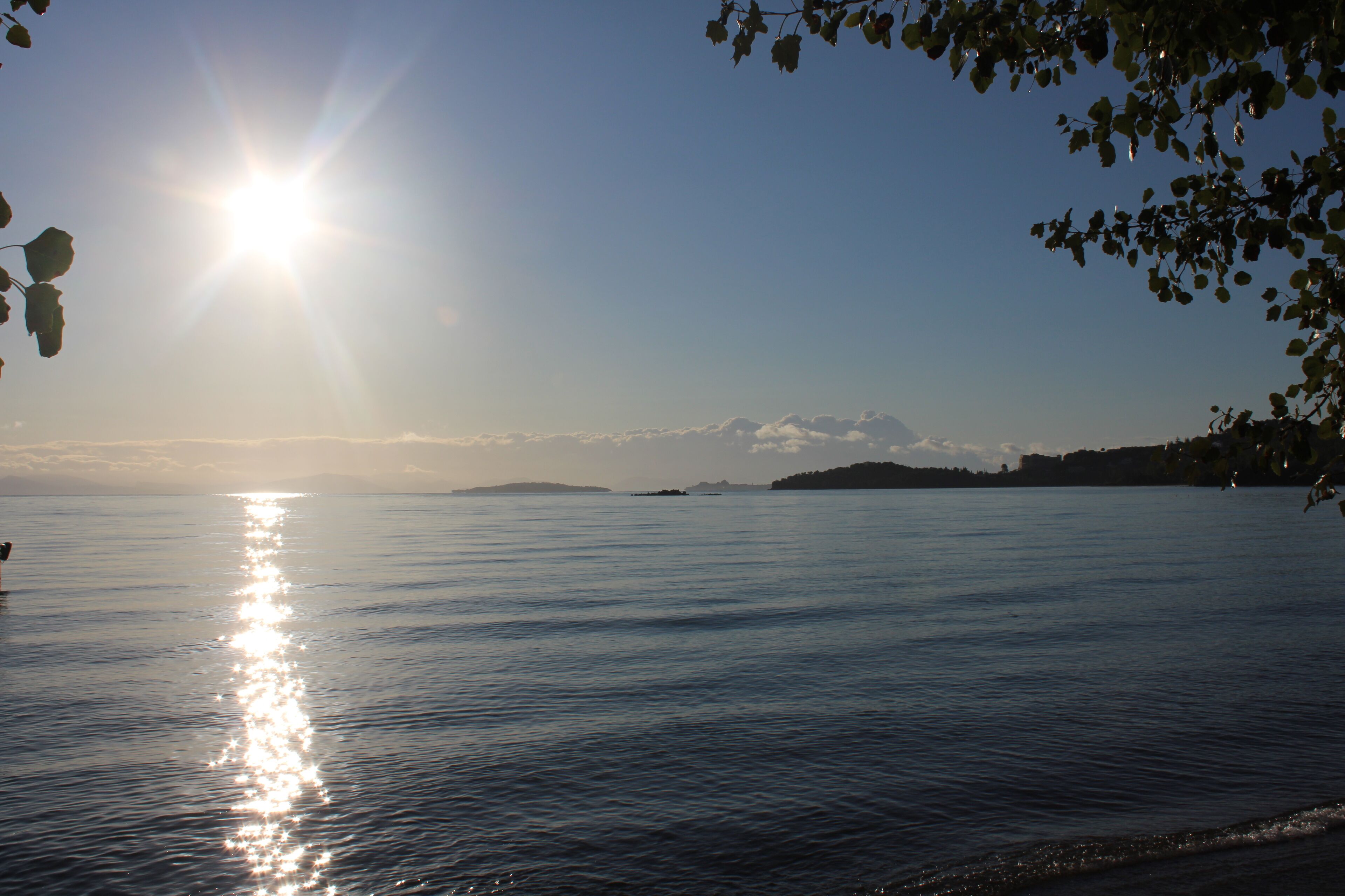 A calm body of water with sunlight reflecting off the surface.