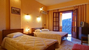 A hotel room with two beds, a TV, and a balcony with curtains. - Olympic Hotel (Delphi)