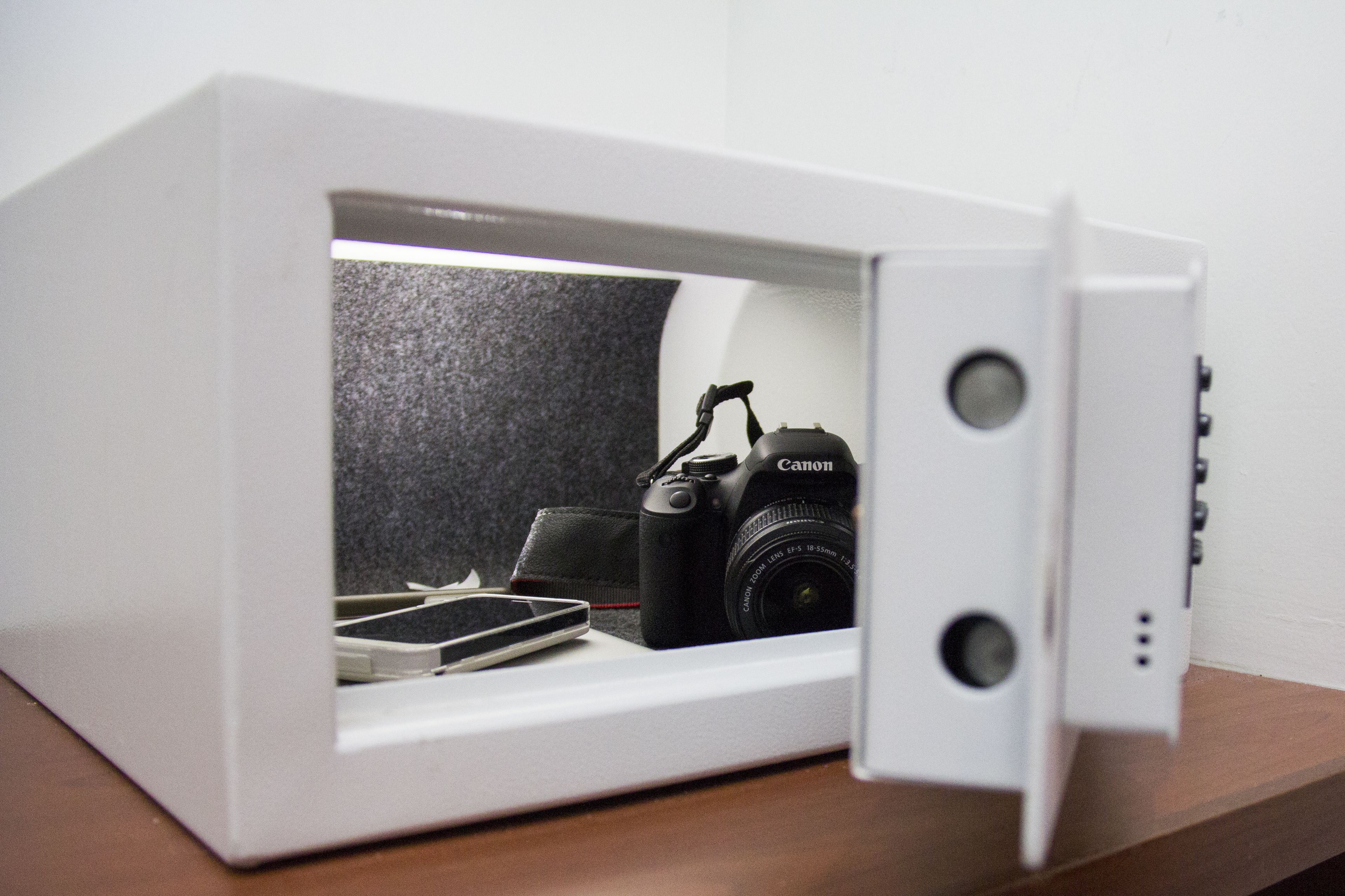 A white cabinet with a Canon camera inside.