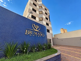 Exterior del Hotel Brumado, con fachada de azulejos azules y cielo despejado.