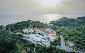 An aerial view of a coastal hotel with multiple buildings, a swimming pool, and lush greenery surrounding the property. - Matilda Hotel by Anayia All Inclusive Resorts (Zakynthos)