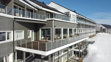 A multi-story hotel with balconies and large windows.