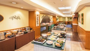 A buffet setup with various food items and a kitchen area in the background. - Hotel Sunroute Niigata (Niigata)