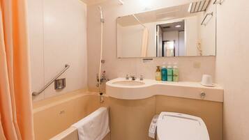 A bathroom with a bathtub, sink, and toilet.