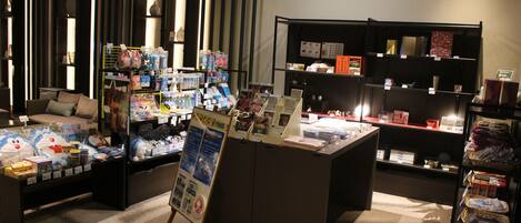A retail store with various products on shelves and tables, including toys and books.