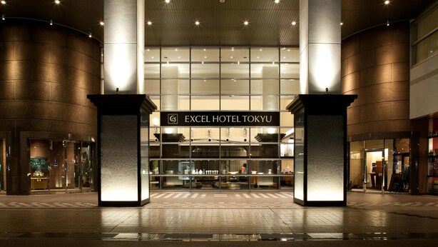 The exterior of Excel Hotel Tokyo with a modern design, featuring large pillars and a well-lit entrance.