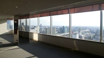 A high-rise office space with large windows offering a city view.