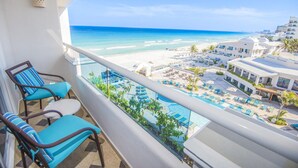 A balcony with a view of a beach and pool area. - Sunscape Cancun Resort & Spa - All Inclusive (Cancun)