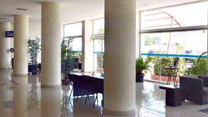 A spacious lobby with a high ceiling, large windows, and a modern design. - Best Western Global Express (Veracruz)
