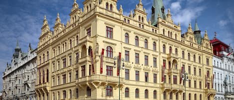 A historic building with multiple ground-floor commercial spaces including restaurants and cafes.