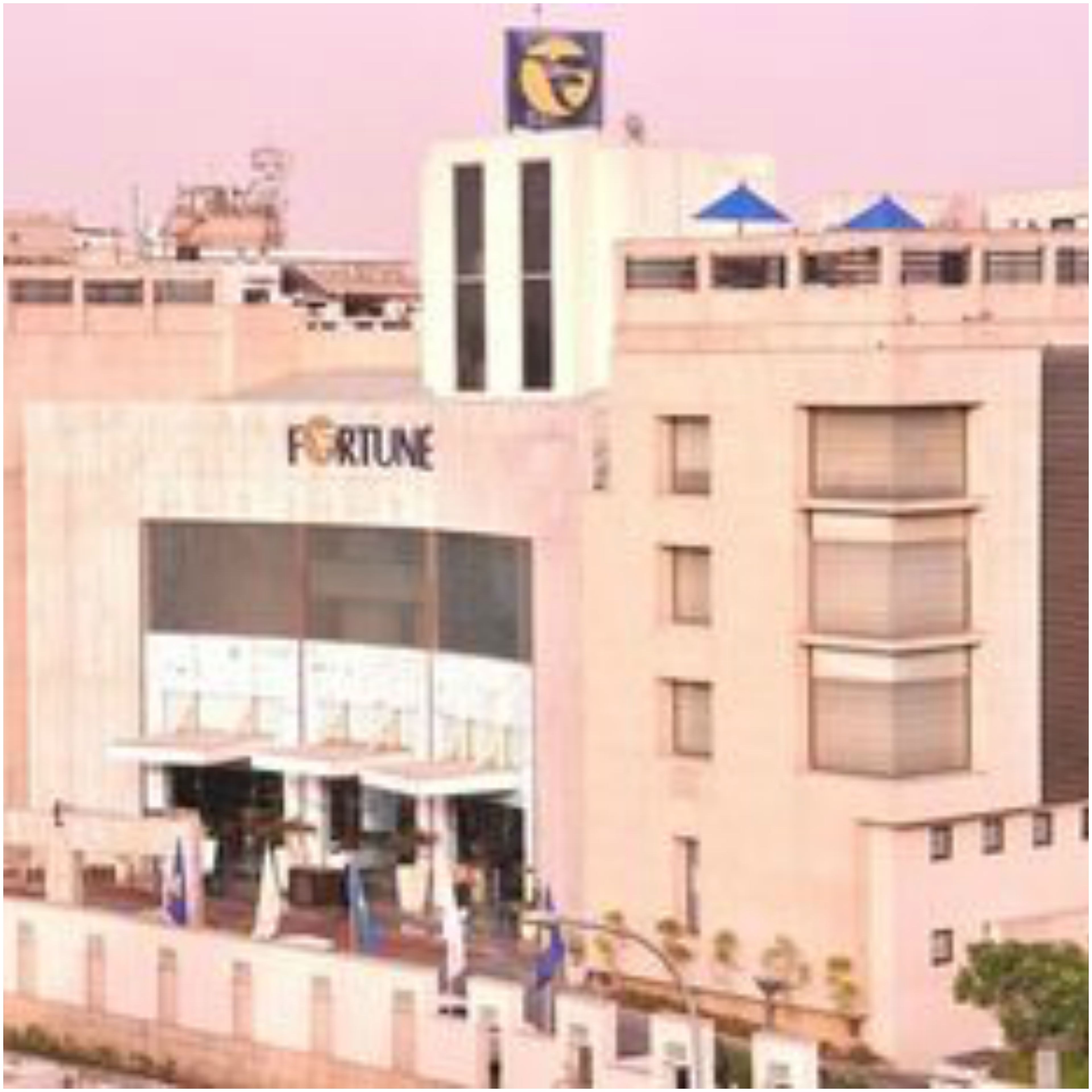 A building with a 'FORTUNE' sign, multiple floors, and a flat facade.