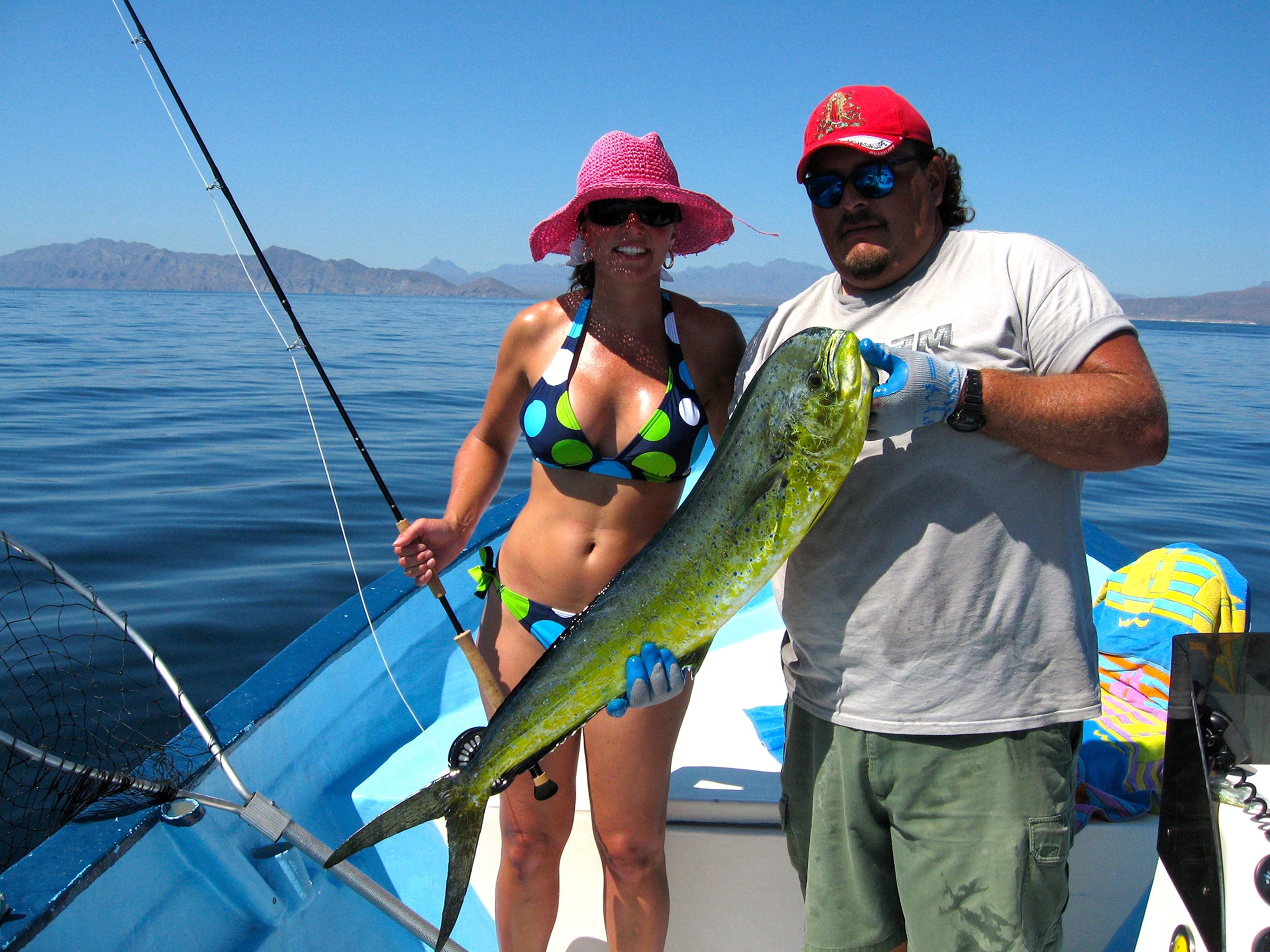 A boat with a net and a large fish.