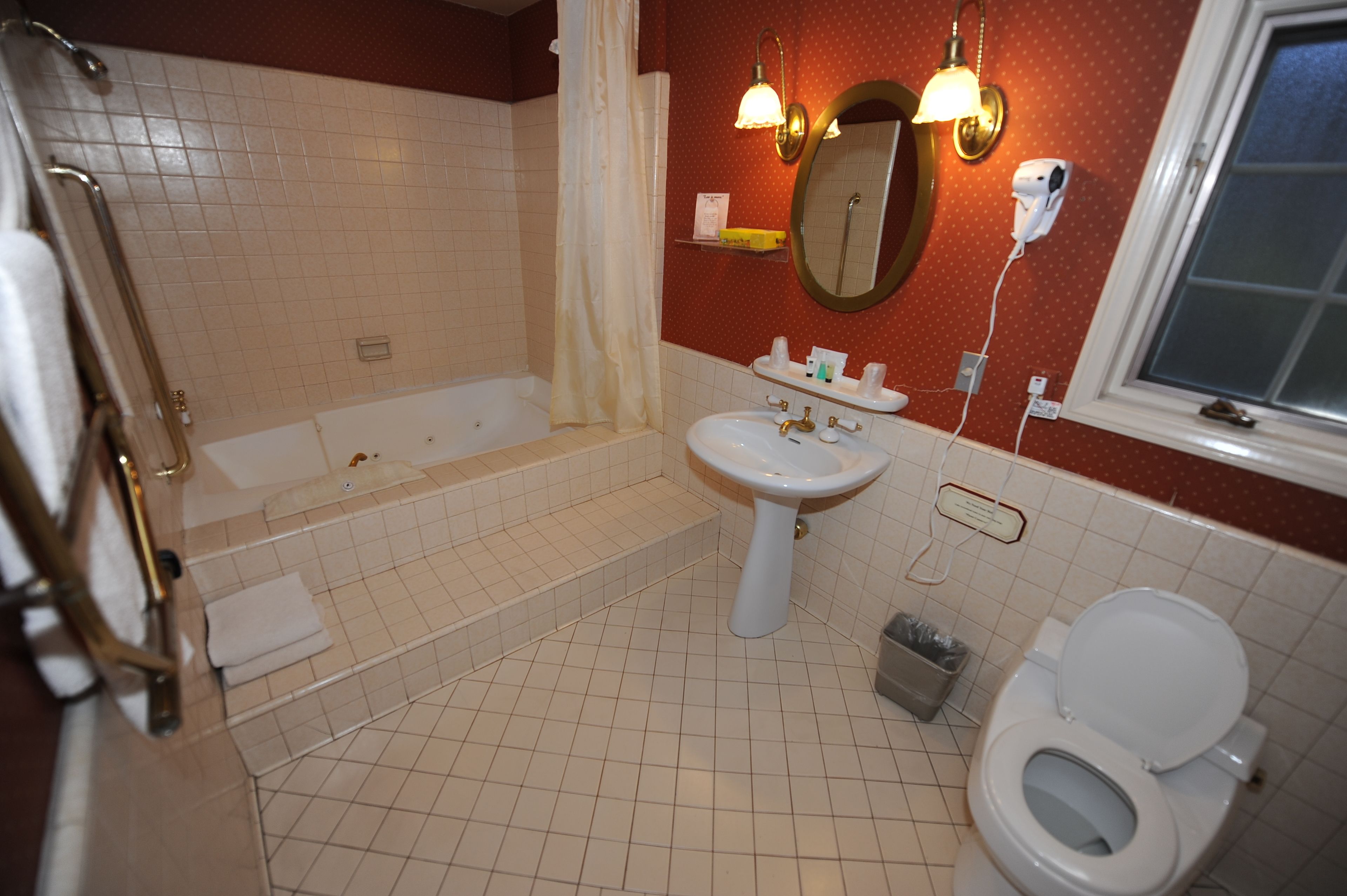 suite, 1 king bed ( with either sofa sleeper or 2 twin rollaways) ac in bedroom only | bathroom | combined shower/bathtub, deep-soaking bathtub, free toiletries